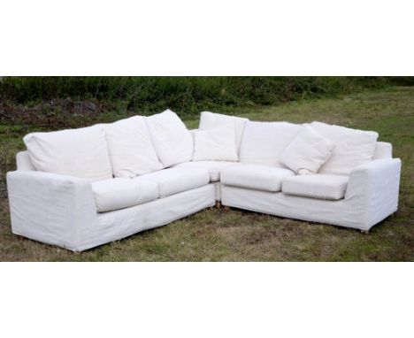 Large modern Heal's Easy corner sofa with cream upholstery and cushions, in three parts, upholstery with label for Roger Lewi