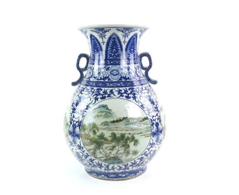 A large Chinese underglaze blue and famille rose decorated vase with flaring, trumpet rim and curvilinear handles; decorated 