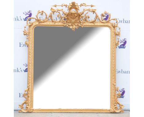 19th century overmantel mirror, ornate finial with mask to centre flanked by scrolling foliage, floral swags and bunches of g