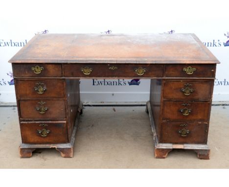 Early 19th century mahogany pedestal writing desk with leather top, two short and one long drawer, each pedestal with three g