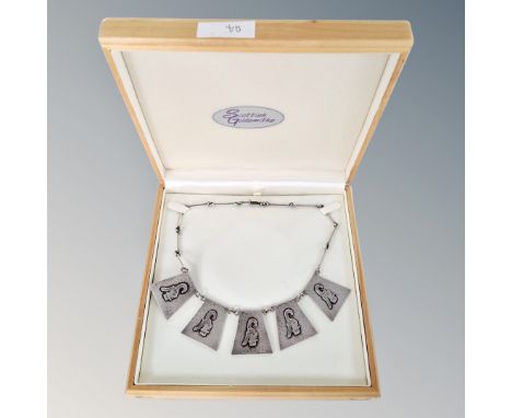 A silver necklace with five panels of Aztec style decoration, weight 26.5g, in box.