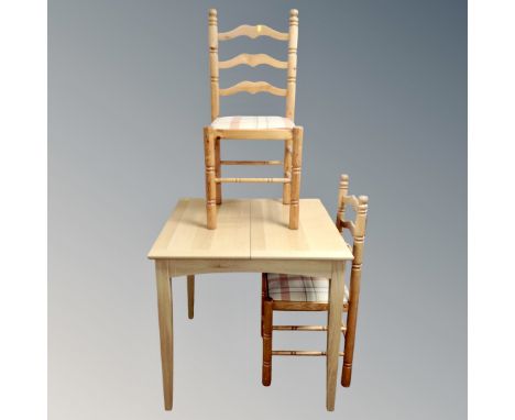 A contemporary square extending table fitted a leaf together with a pair of pine ladder backed chairs 