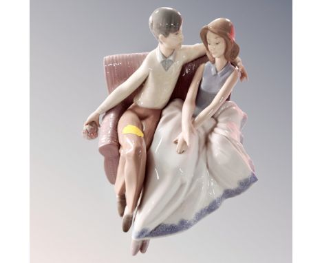 A Nao figure - couple seated on sofa 