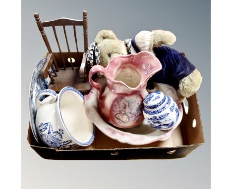 A box containing floral blue and white chamber pot, Ringtons tea jar, wash jug and basin, soft toy teddy bear on rocking chai