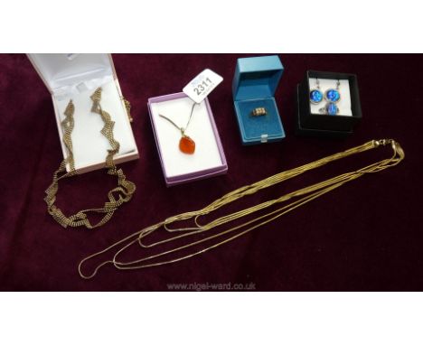 An amber pendant and chain, a gold coloured 18" five strand necklace, a gold coloured 16" necklace, a blue stone ring and mat