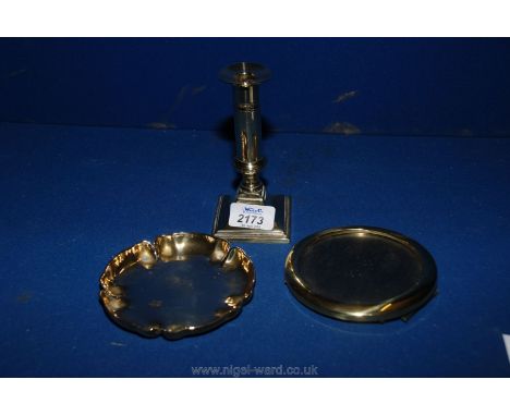 A brass candlestick together with a brass dish impressed stamp to base and a brass photo frame