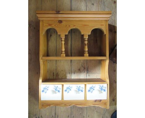 A pine set of wall shelves, fitted with three ceramic drawers