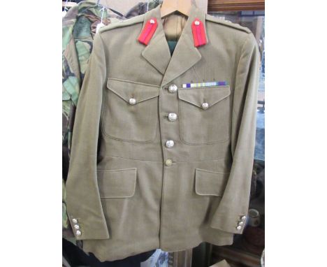 A military Army issue jacket, with badge ribbons and stitched badges to the lapels