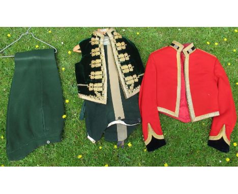 An Army issue ceremonial red jacket, with gold braiding and embroidered lapel badges, together with a green velvet waistcoat 