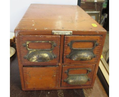 A wooden four drawer filing box, containing a collection of glass magic lantern slides