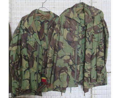 Two army issue camouflage jackets and trousers, one pair of trousers with belt