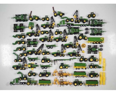 A large quantity of 1:87 HO scale diecast tractors and other farming equipment by various manufacturers, all in John Deere br