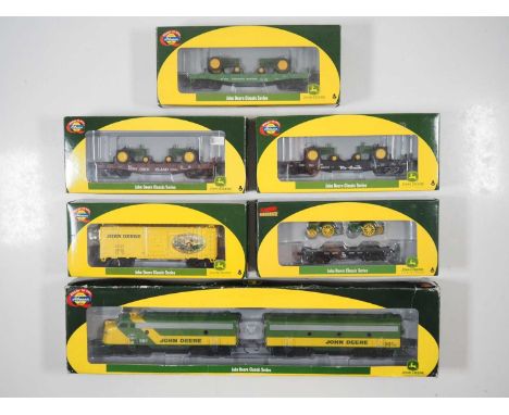 A group of boxed HO gauge American outline locomotives and rolling stock from the ATHEARN limited edition John Deere Railway 