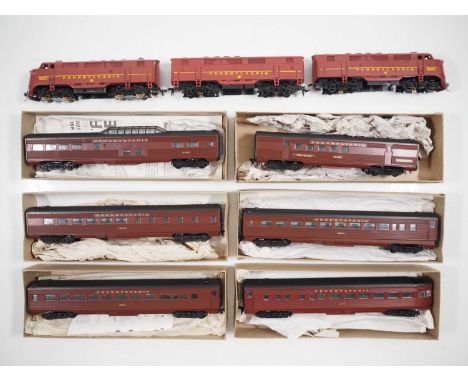 A group of American outline HO gauge locomotives and rolling stock by ATHEARN in Pennsylvania RR Tuscan red livery comprising
