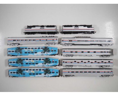 A group of American outline HO gauge locomotives and rolling stock by BACHMANN and others in Amtrak livery together with a tr