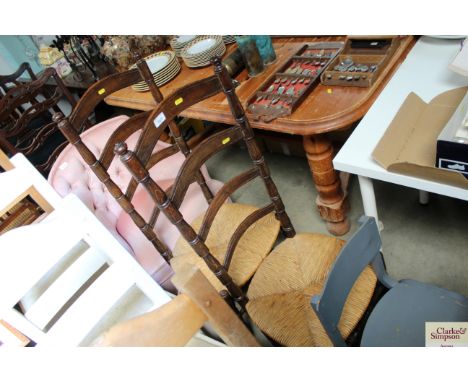 A pair of oak ladder back chairs