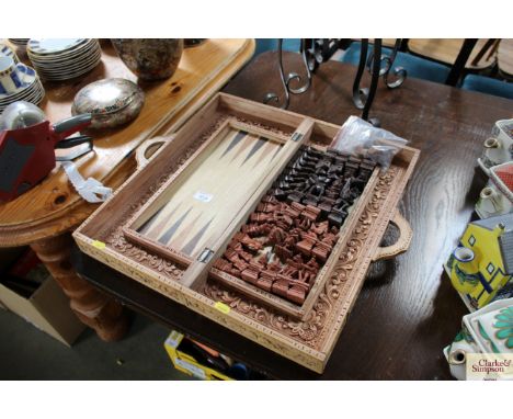 A carved travelling game set comprising of backgammon and chess