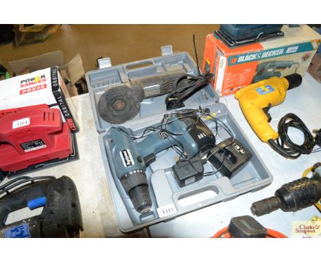 An Ago Jama cordless drill with battery and charger and a Black &amp; Decker angle grinder