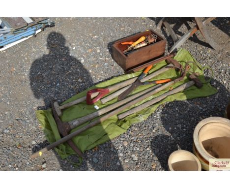 A quantity of long handled tools including sledge hammers, hoe, pick axe etc, and a box containing hand tools, garden line et