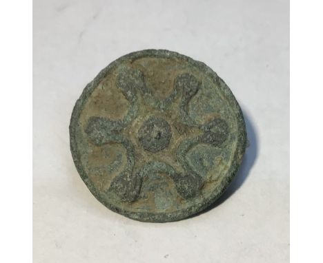 A 1st - 2nd century A.D. Roman Disc Brooch. Cast in bronze this brooch is of disc type and displays a sunburst of the Roman m