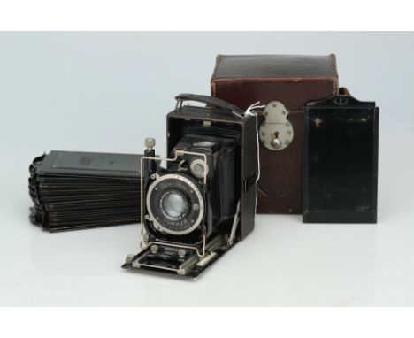 A Zeiss Ikon Trona 210 Folding Camera,black, body G-VG, shutter working, with a Tessar 105mm f/4.5 lens, optics G, some haze 