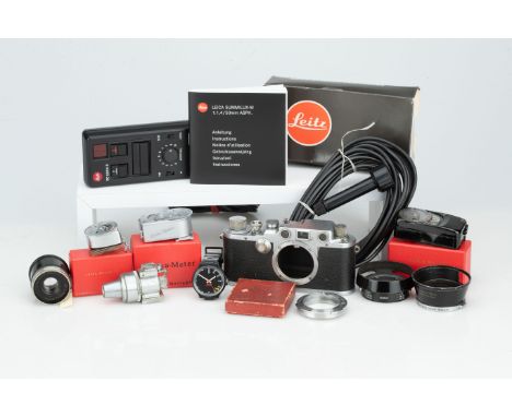 A Leica IIIc 35mm Rangefinder Camera,chrome, serial no. 374634, c.1941, body P-F, shutter working, with a selection of Leitz 