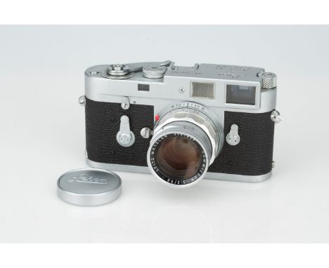 A Leica M2 Rangefinder Camera,chrome, serial no. 1021928, with Leitz Summicron f/2 50mm lens, body, F, shutter working, slow 