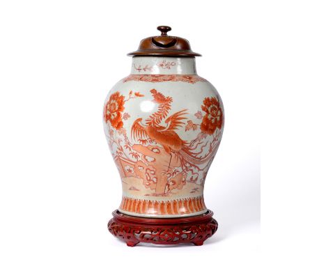 A Chinese Porcelain Baluster Jar, 18th century, painted in iron red with phoenix perched on a rock in a fenced garden within 