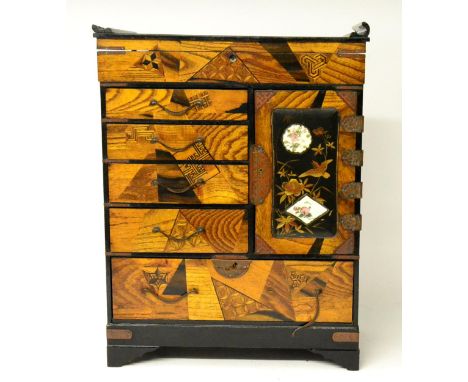 A Japanese Lacquer Table Cabinet, Meiji period, the hinged top over an arrangement of five drawers, a hinged door enclosing t