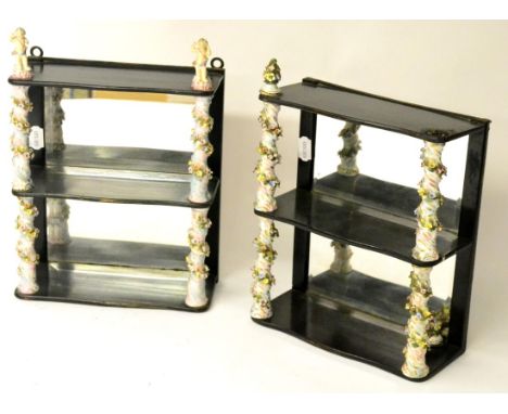 A Matched Pair of Dresden Mounted Ebonised and Mirror-Backed Wall Shelves, early 20th century, with foliate encrusted wrythen