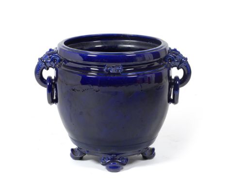 A Minton Blue Ground Pottery Jardinière, circa 1870, attributed to Dr Christopher Dresser, of ovoid form with elephant mask a
