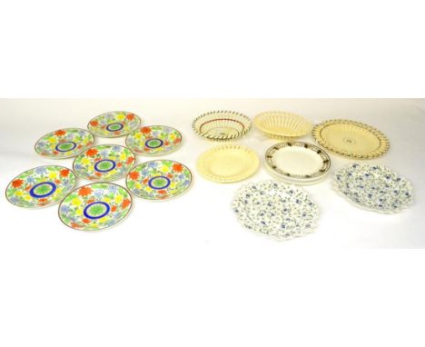 A Set of Seven Pearlware Dessert Plates, early 19th century, painted with a central green flower within a blue ring on a grou