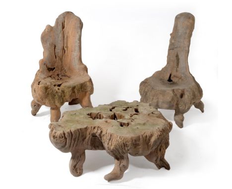 Two Garden Chairs, of naturalistic form, carved and formed from a tree trunk with back support and shaped seat, raised on leg