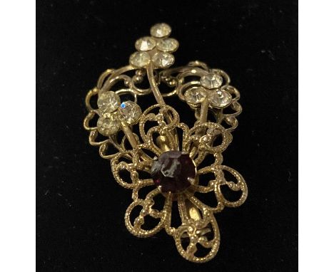 GRETA GARBO OWNED JEWELLERY. A piece of costume jewellery once owned by Greta Garbo, comprising a delicate brooch with rhines