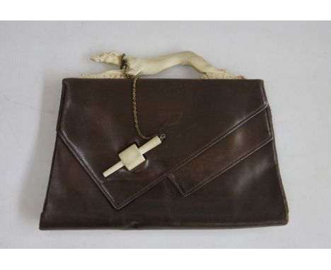Brown leather vintage bag, the fixed bakelite handle formed as a running greyhound, the bakelite fastening on a chain around 