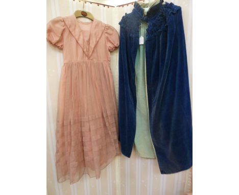 A&nbsp; child's vintage blue velvet party cloak, lined with turquoise velvet, ruched collar and ribbon tie at the neck. a chi