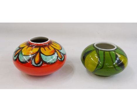 Two Poole pottery squat vases, shape no. 32, one orange ground and one green (2) 12cm and 10cm high approx.&nbsp;