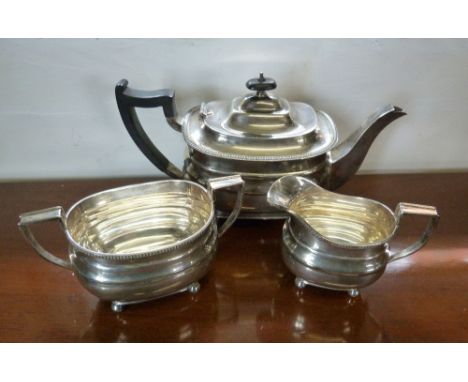 A Sheffield Silver George III Style Three Piece Tea Service, comprising teapot, cream jug and two handled sucrier, 33 ozs. al