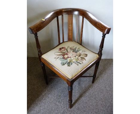 An Edwardian Mahogany Marquetry Inlaid Corner Armchair, with a tapestry seat and crossover stretchers raised upon turned tape