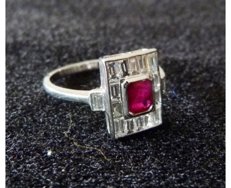 An 18ct. White Gold Art Deco Style Ruby and Diamond Ring, with a central square ruby surrounded by baguette diamonds within a