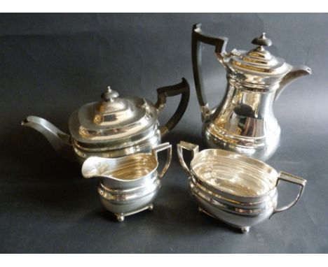 A Sheffield Silver Four Piece Tea Service, comprising teapot, hot water pot, cream jug and two handled sucrier, 56 ozs.