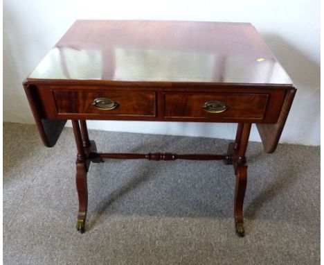 A Mahogany Line Inlaid Sofa Table, a drop flap top above two frieze drawers with brass handles opposed by dummy drawers, rais