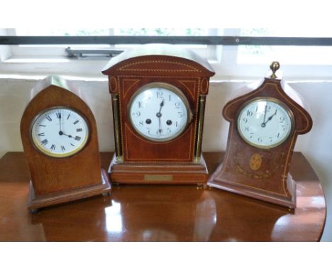 An Edwardian Mahogany Line Inlaid Mantle Clock, the enamel dial with Arabic numerals and two train movement, together with tw