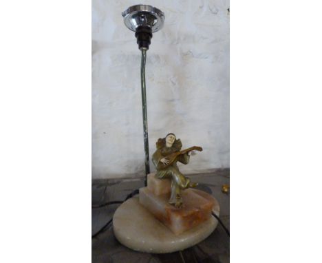 An Art Deco Table Lamp, in the form of a figure playing a banjo upon a marble base, 18 cms tall