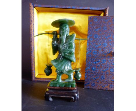 An Early 20th Century Chinese Jade Model in the form of a Fisherman, within a fitted lined box, 18 cms tall