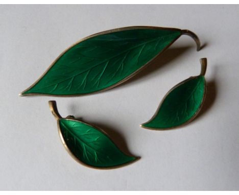 A Norwegian Sterling Silver and Green Enamel Brooch in the form of a Leaf, together with a pair of matching ear clips