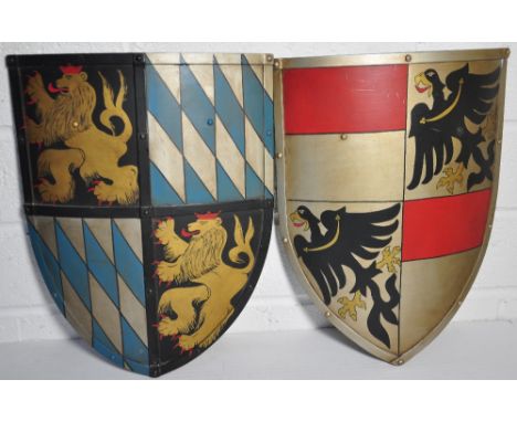 Two painted metal shields props from the television programme "Henry VIII" starring Ray Winston, both inscribed to the revers