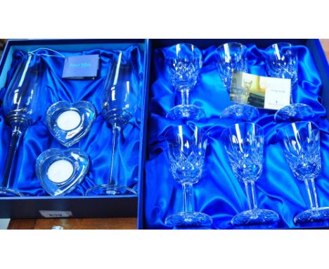 A pair of boxed Avola Blue Collection large crystal champagne flutes with white metal twist design to the base, a pair of hea