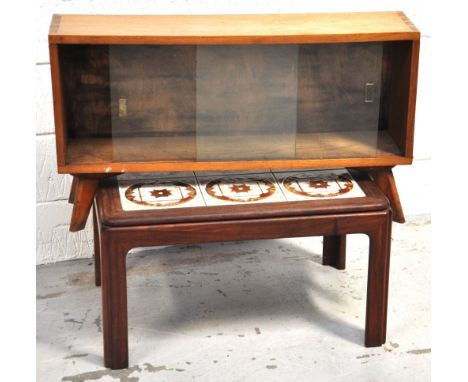 A 1970s light oak glazed bookcase on outsplayed legs, width 90cm, together with a retro tiled top coffee table, width 70cm.