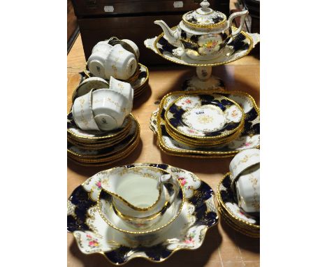 A c.1880 Coalport part tea service in the cobalt blue batwing pattern hand painted with floral sprays and gilded, comprising 